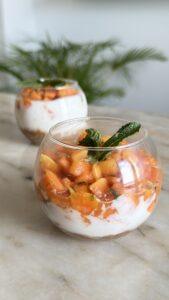 No-bake papaya dessert in a glass with almond-date base, cashew cream and fresh papaya